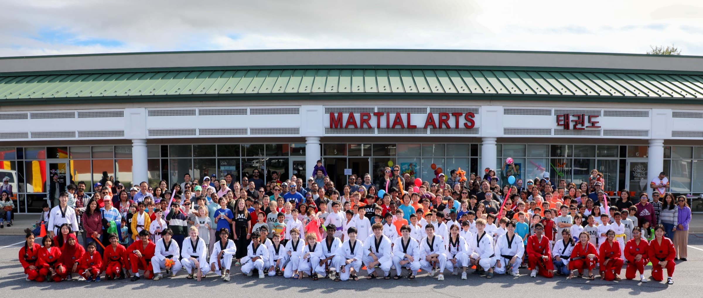 The S Martial Arts family gathered in front of the dojang for the 14th Anniversary celebration